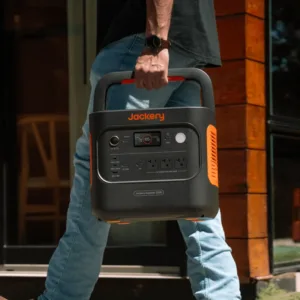 Jackery Explorer 2000 v2 being carried by its fold-down handle, about 39.5 lb