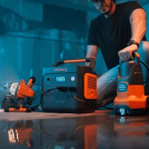 Jackery Explorer 2000 v2 powering a cordless tool charger in a workshop